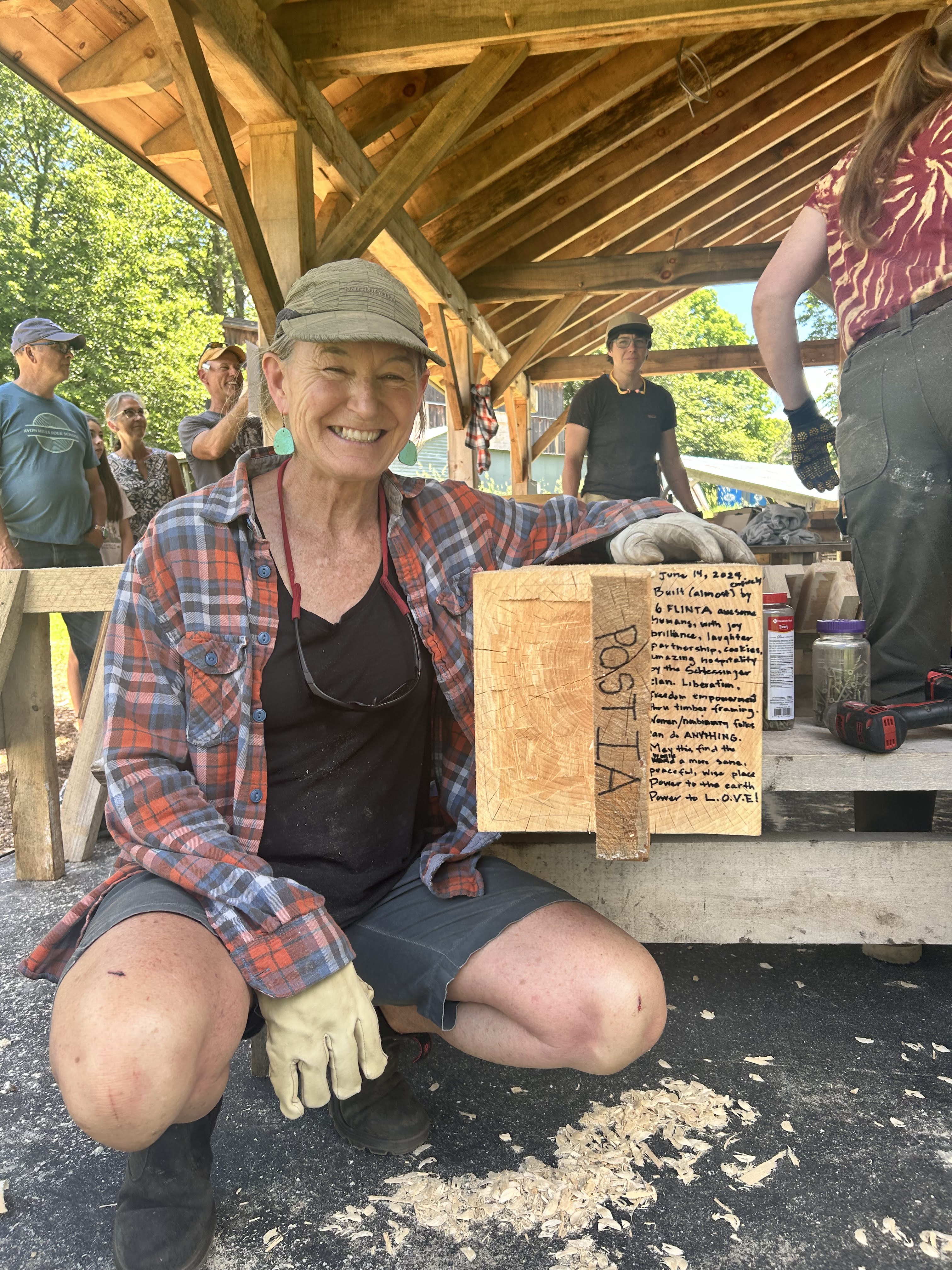 Student of a FLINTA timber framing course and now Timber Club Member, showing a finished tenon on a timber frame post.