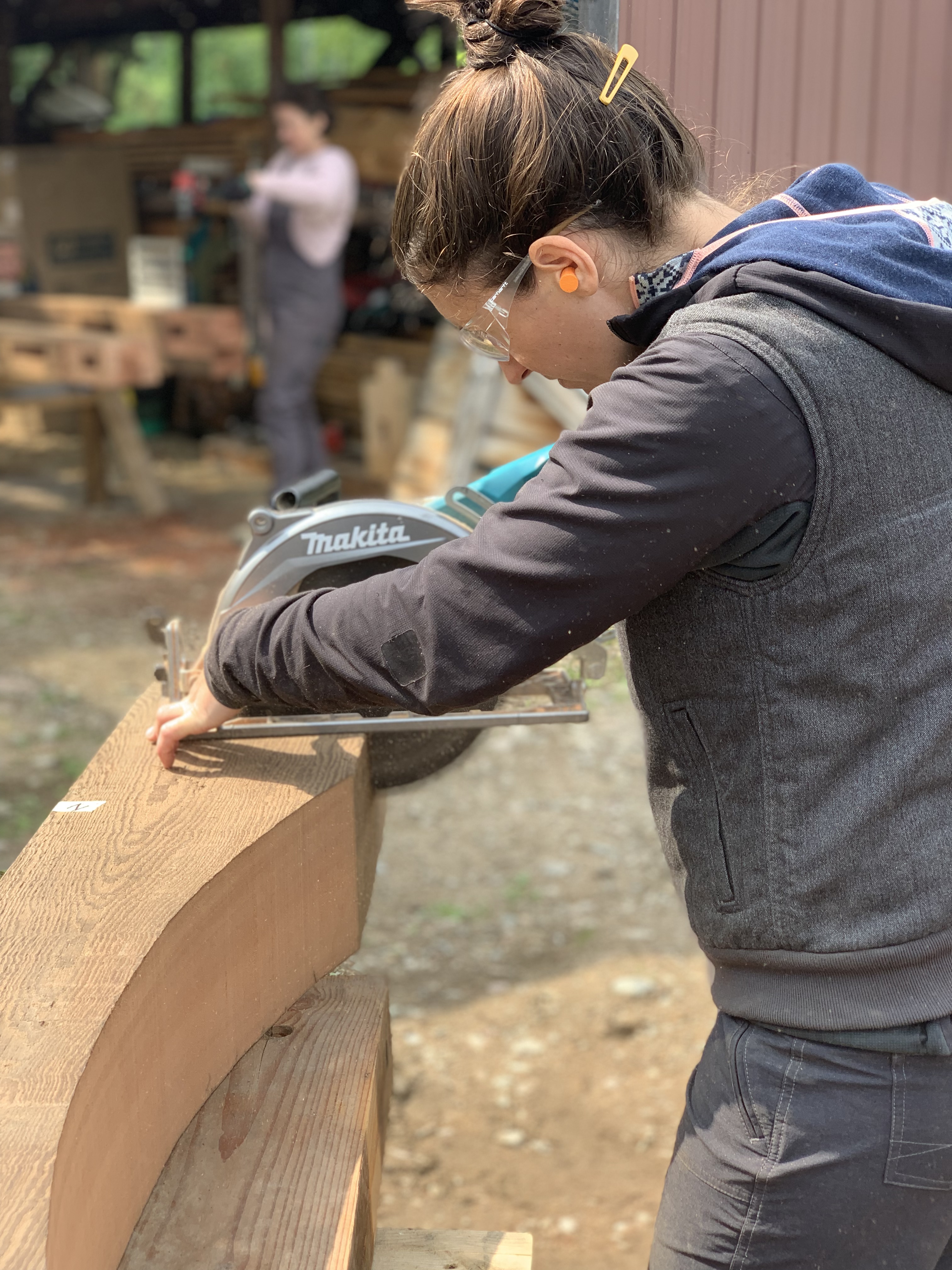 Student of a women's timber framing course and now Timber Club Member, working on a tie beam for a timber frame.